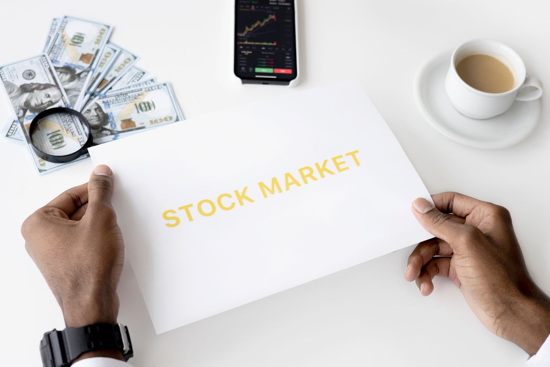 Business theme with stock market document, currency, and mobile display.