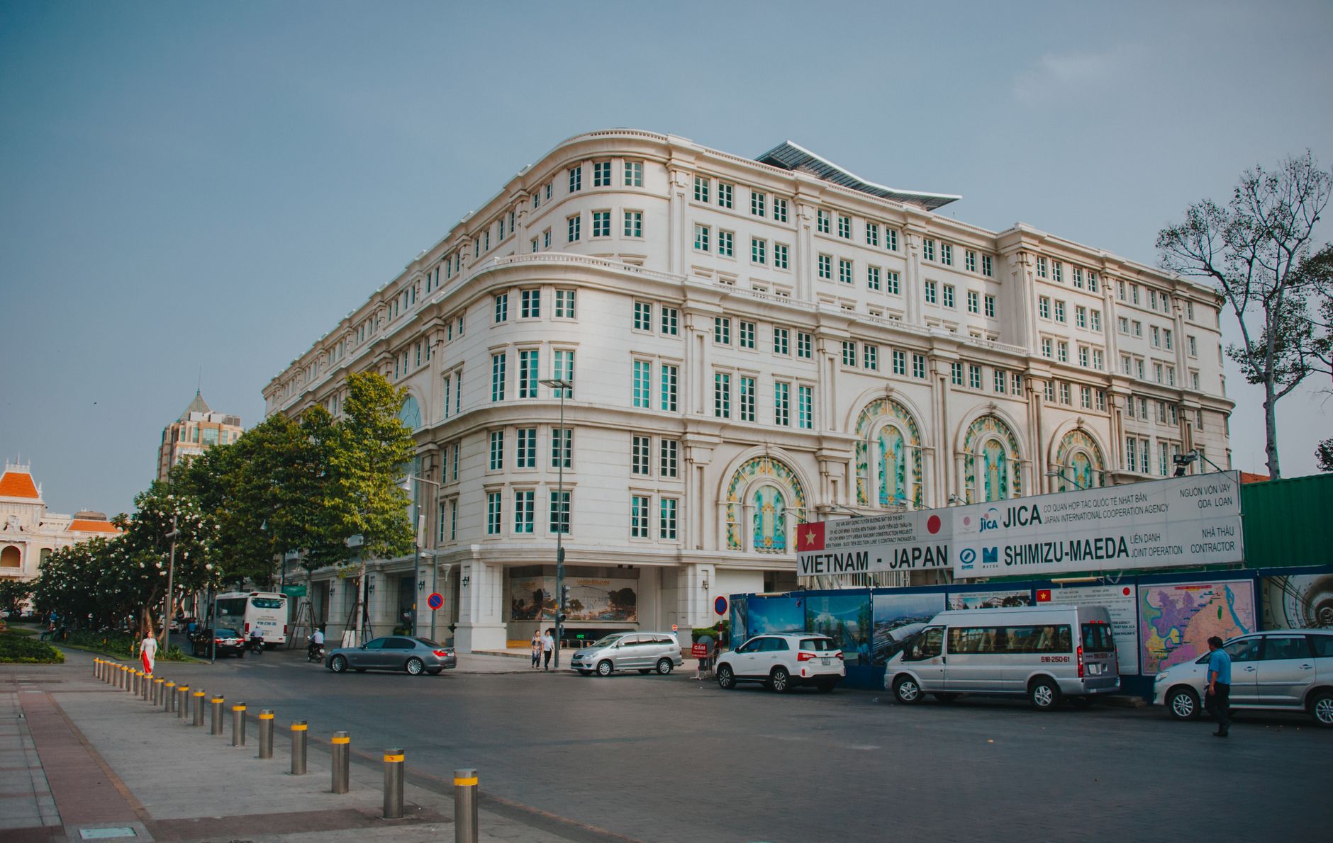 Elegant colonial-style building on a city street in Ho Chi Minh City, Vietnam.