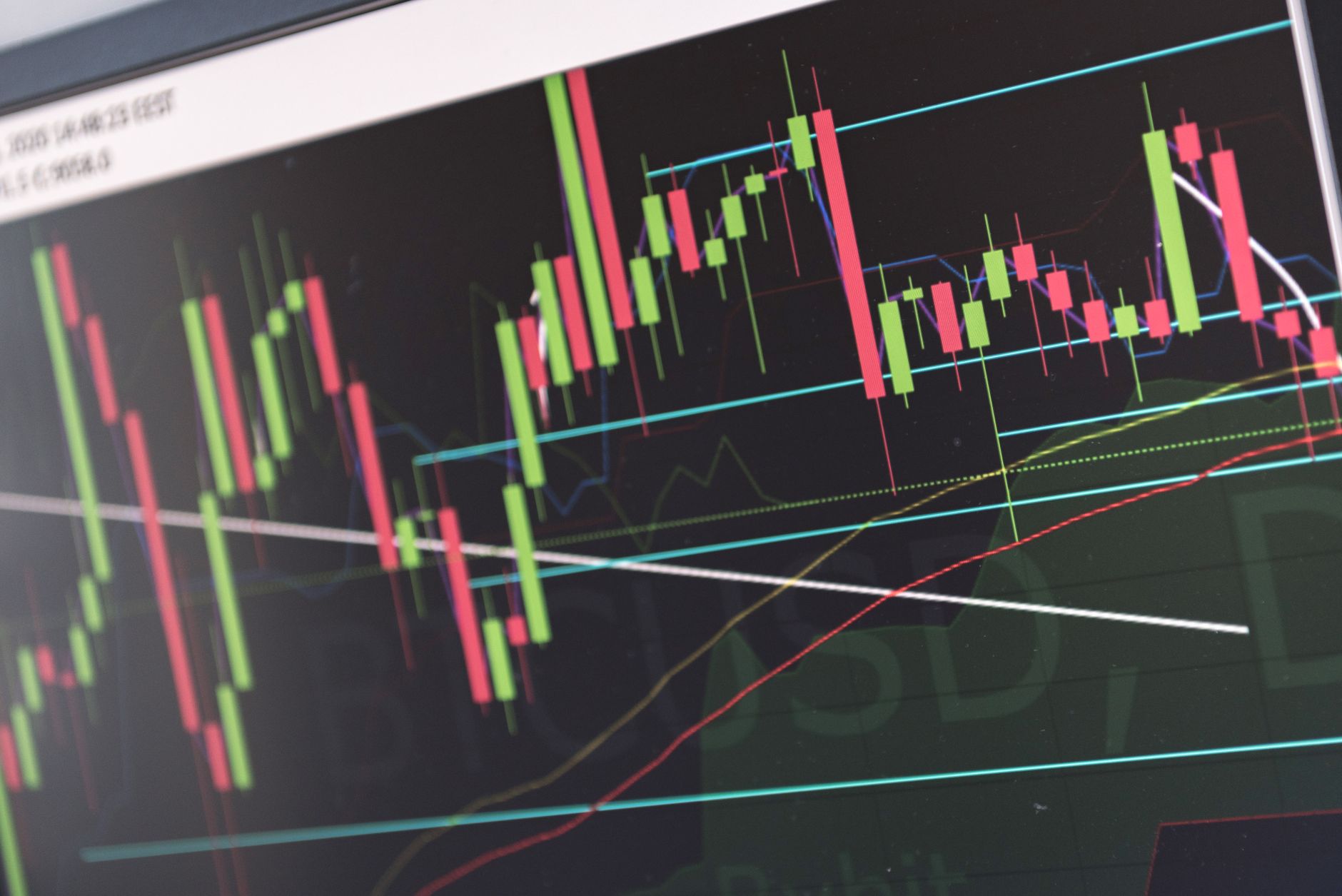 Close-up of vibrant stock market graphs displaying trading trends on a monitor, ideal for finance and cryptocurrency concepts.